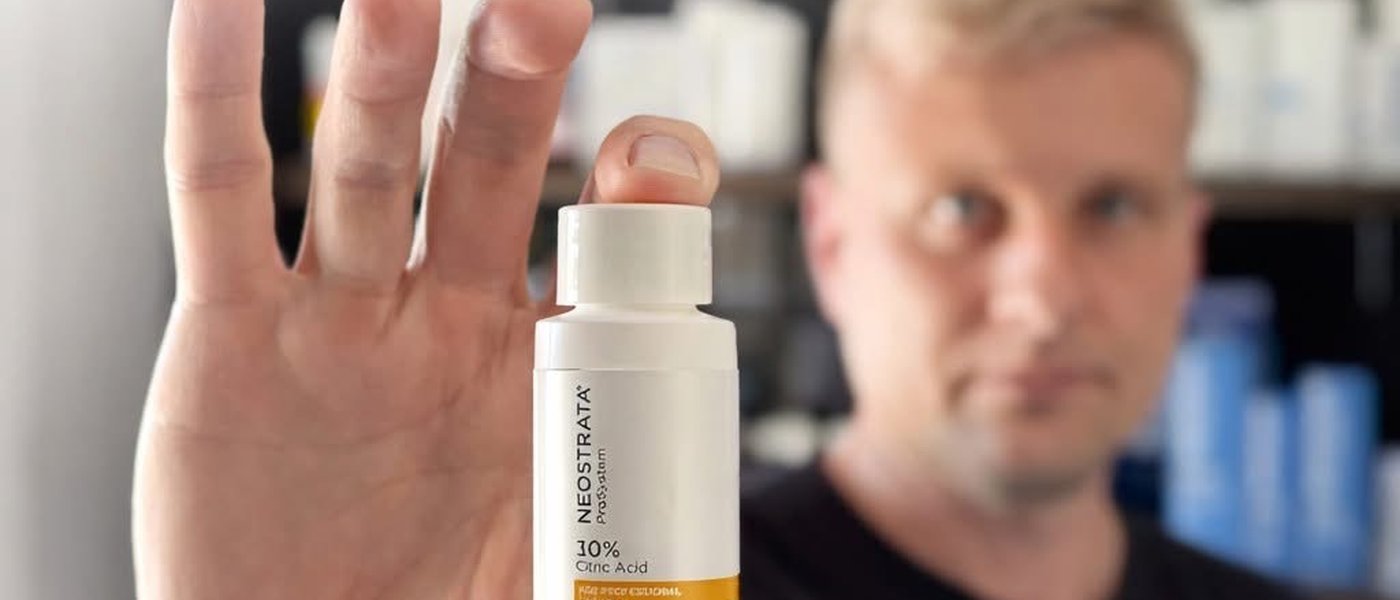 Wynand Neethling holding a NeoStrata Brightening Peel Booster at JAWY Skin & Hair